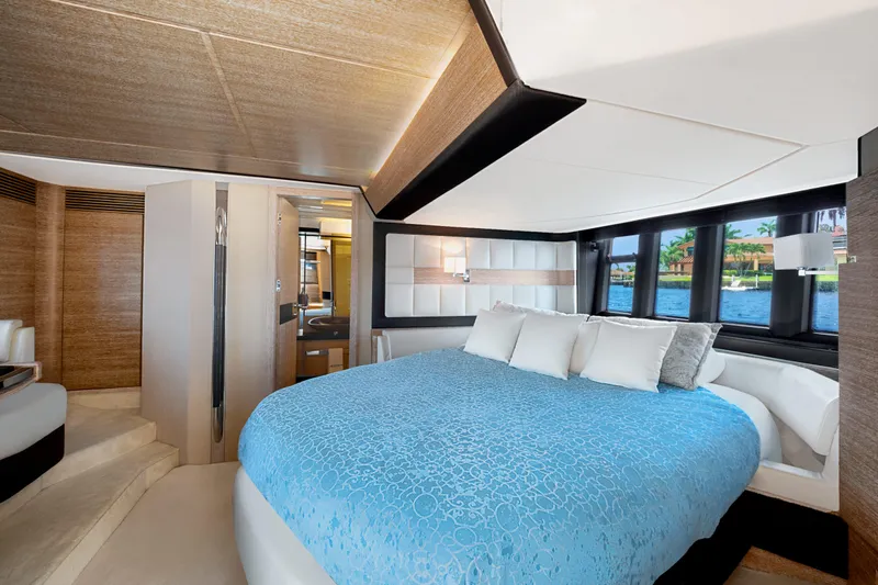  Yacht Photos Pics Luxurious bedroom interior of 2013 Azimut 64 yacht with blue bedding and scenic window view.