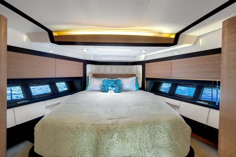  Yacht Photos Pics Luxurious bedroom interior of 2013 Azimut 64 yacht with elegant bedding and panoramic windows.