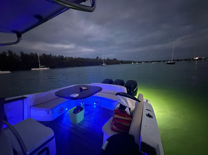  Yacht Photos Pics Sessa Marine Key Largo 36 boat, 2013 model, with blue interior lights on a calm night.