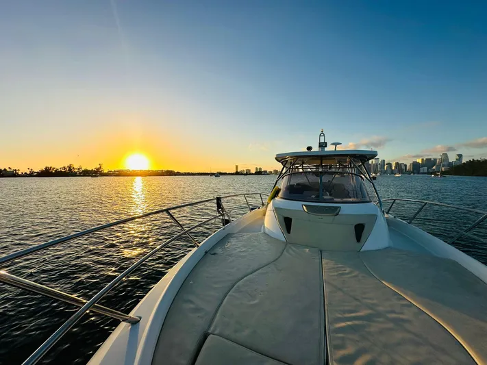  Yacht Photos Pics Sessa Marine Key Largo 36, 2013, cruising at sunset with city skyline in background.