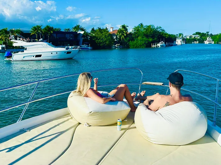  Yacht Photos Pics Couple relaxing on a 2013 Sessa Marine Key Largo 36 yacht, enjoying a sunny day on the water.