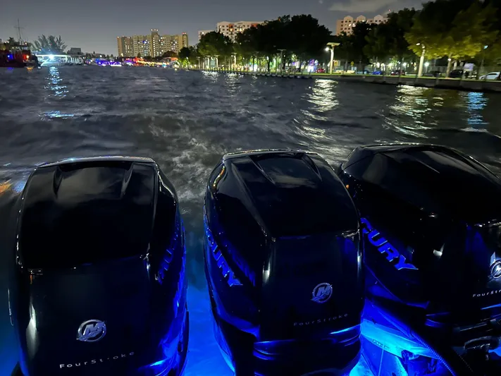  Yacht Photos Pics Sessa Marine Key Largo 36 boat engines at night, illuminated by blue lights.