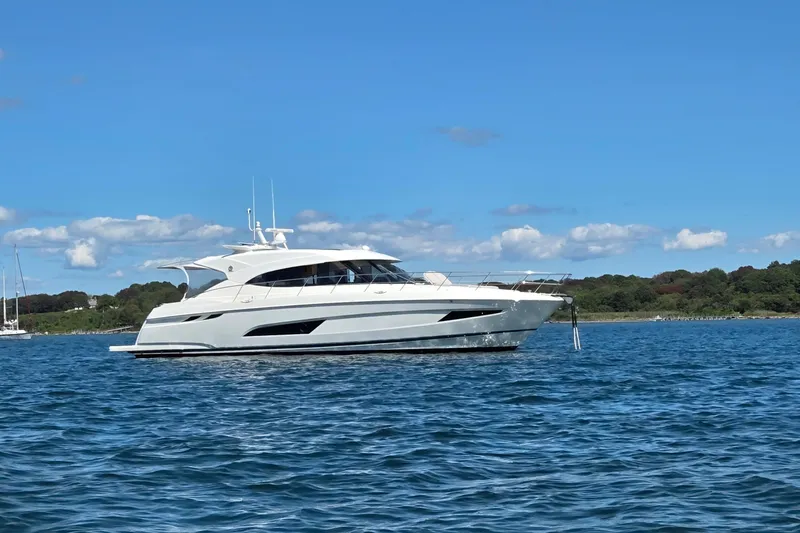 Happy Ours Yacht Photos Pics 2019 Riviera 5400 Sport Yacht on calm water under clear blue sky.
