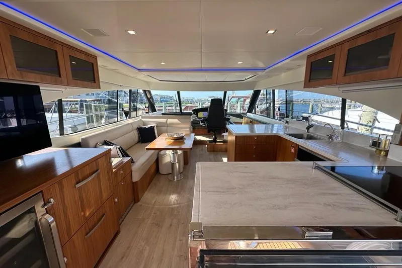 Happy Ours Yacht Photos Pics Luxurious interior of 2019 Riviera 5400 Sport Yacht with modern furnishings and panoramic windows.