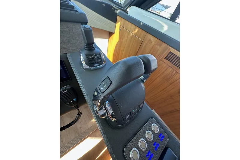 Happy Ours Yacht Photos Pics Control panel of a 2019 Riviera 5400 Sport Yacht with joystick and throttle levers.