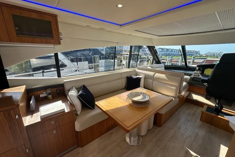 Happy Ours Yacht Photos Pics Luxurious interior of 2019 Riviera 5400 Sport Yacht with elegant seating and dining area.