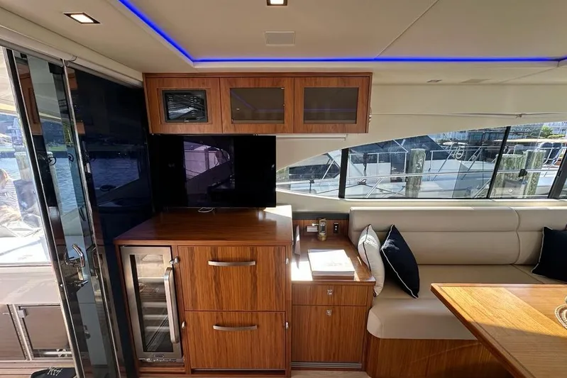 Happy Ours Yacht Photos Pics Interior of 2019 Riviera 5400 Sport Yacht with elegant wood cabinetry and seating.