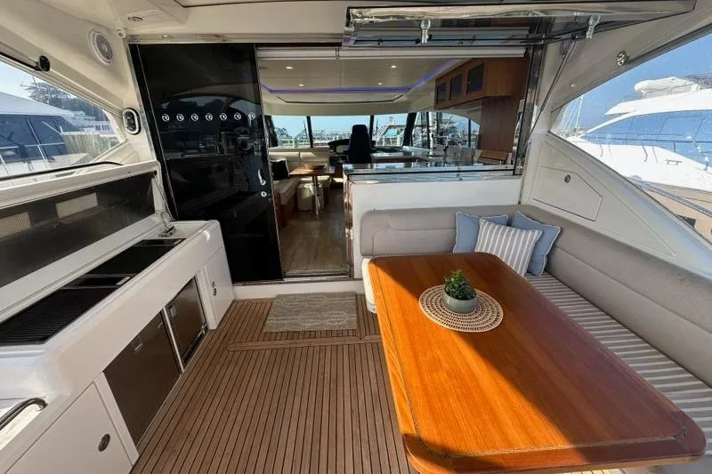 Happy Ours Yacht Photos Pics Luxurious 2019 Riviera 5400 Sport Yacht interior with elegant seating and dining area.