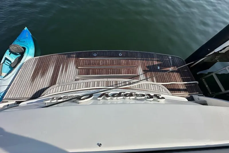 Happy Ours Yacht Photos Pics 2019 Riviera 5400 Sport Yacht with wooden deck and kayak on water.