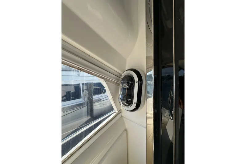Happy Ours Yacht Photos Pics Interior view of 2019 Riviera 5400 Sport Yacht window and light fixture.
