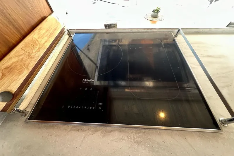 Happy Ours Yacht Photos Pics Miele induction cooktop on 2019 Riviera 5400 Sport Yacht kitchen counter.