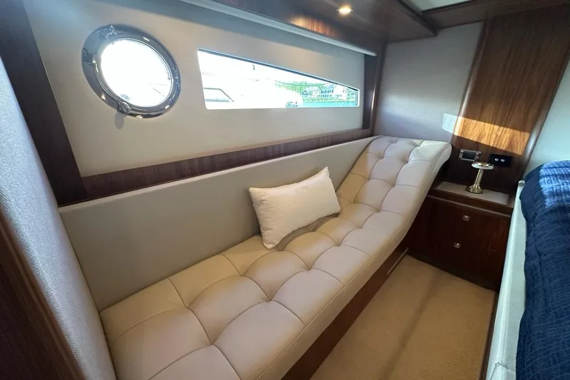 Happy Ours Yacht Photos Pics Luxurious interior of 2019 Riviera 5400 Sport Yacht with plush seating and elegant decor.