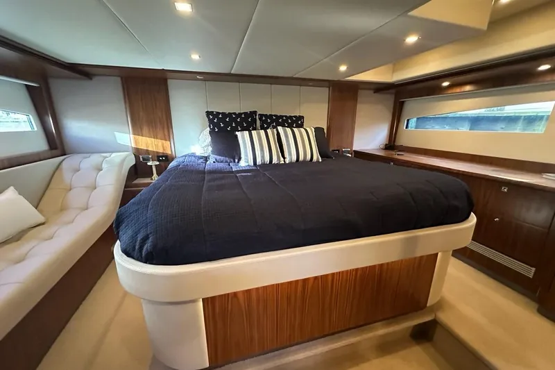Happy Ours Yacht Photos Pics Luxurious bedroom interior of 2019 Riviera 5400 Sport Yacht with elegant wood finishes.
