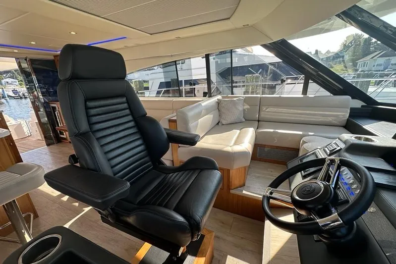 Happy Ours Yacht Photos Pics Luxurious interior of 2019 Riviera 5400 Sport Yacht with leather seating and modern helm.
