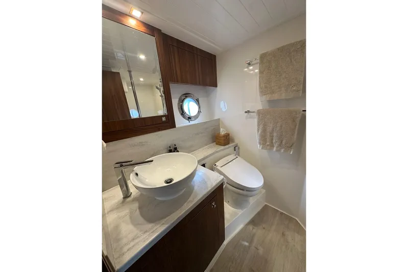 Happy Ours Yacht Photos Pics Luxurious bathroom in 2019 Riviera 5400 Sport Yacht with modern fixtures and elegant design.