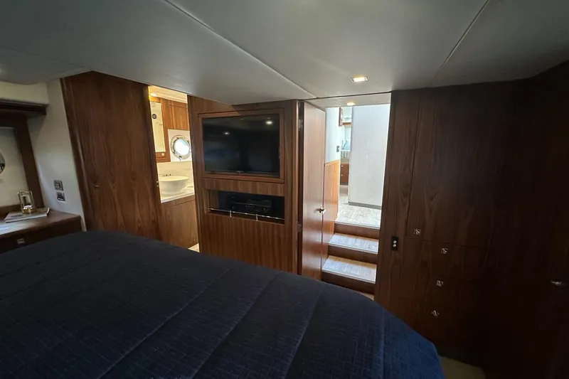 Happy Ours Yacht Photos Pics Luxurious interior of 2019 Riviera 5400 Sport Yacht with wood finish and modern amenities.