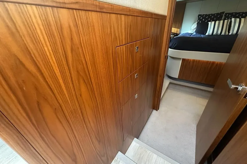 Happy Ours Yacht Photos Pics Interior of 2019 Riviera 5400 Sport Yacht with wood paneling and bedroom view.