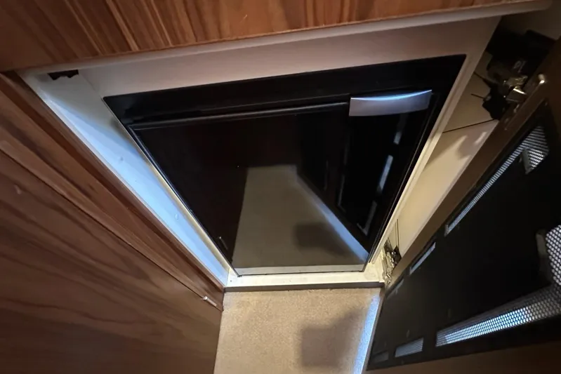 Happy Ours Yacht Photos Pics 2019 Riviera 5400 Sport Yacht interior with open cabinet and black appliance.