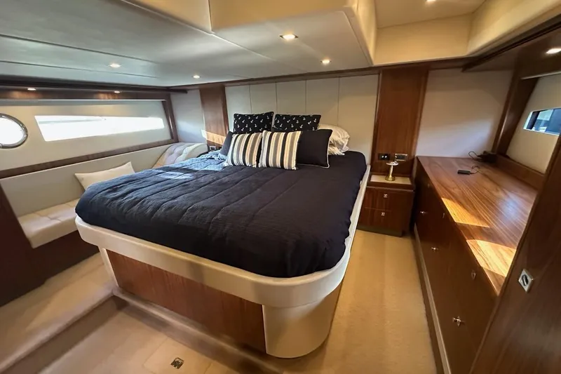 Happy Ours Yacht Photos Pics Luxurious bedroom interior of 2019 Riviera 5400 Sport Yacht with elegant wood finishes.