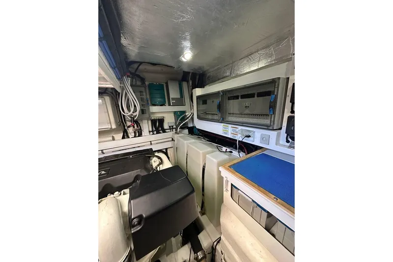 Happy Ours Yacht Photos Pics Engine room of 2019 Riviera 5400 Sport Yacht, showcasing electrical panels and equipment.