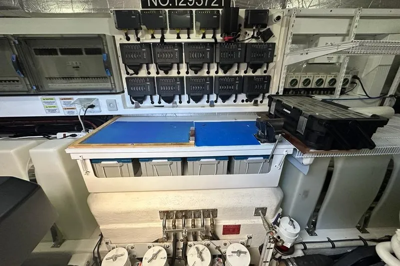 Happy Ours Yacht Photos Pics Engine room of 2019 Riviera 5400 Sport Yacht with electrical panels and storage compartments.