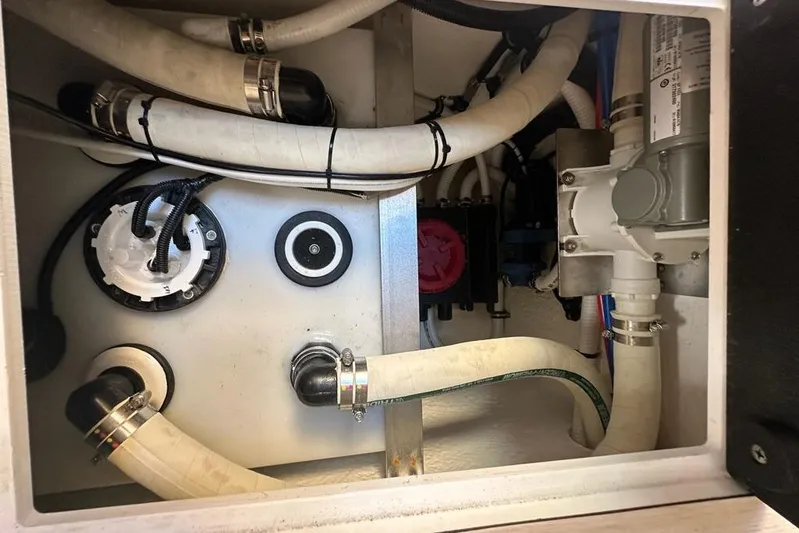 Happy Ours Yacht Photos Pics Engine compartment of a 2019 Riviera 5400 Sport Yacht, showing hoses and mechanical components.