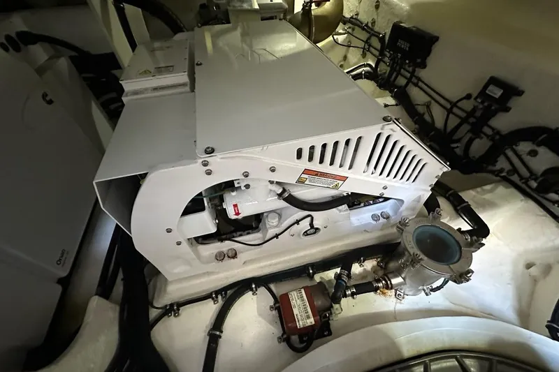 Happy Ours Yacht Photos Pics Engine room of 2019 Riviera 5400 Sport Yacht, showcasing mechanical components and wiring.