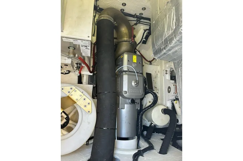 Happy Ours Yacht Photos Pics Engine room of 2019 Riviera 5400 Sport Yacht, showcasing mechanical components and piping.