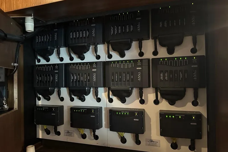 Happy Ours Yacht Photos Pics Electrical control panel on 2019 Riviera 5400 Sport Yacht, featuring multiple switches and indicators.