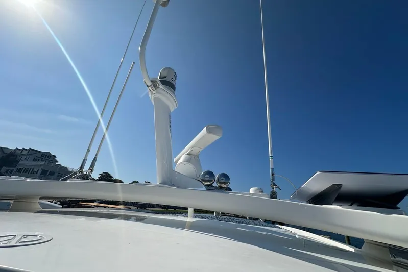 Happy Ours Yacht Photos Pics 2019 Riviera 5400 Sport Yacht with radar and antennas under clear blue sky.