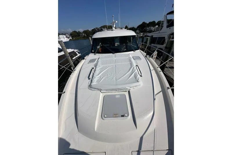 Happy Ours Yacht Photos Pics 2019 Riviera 5400 Sport Yacht docked, showcasing sleek design and spacious deck.