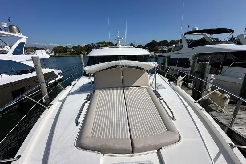 Happy Ours Yacht Photos Pics 2019 Riviera 5400 Sport Yacht docked, featuring spacious sunbathing area and sleek design.