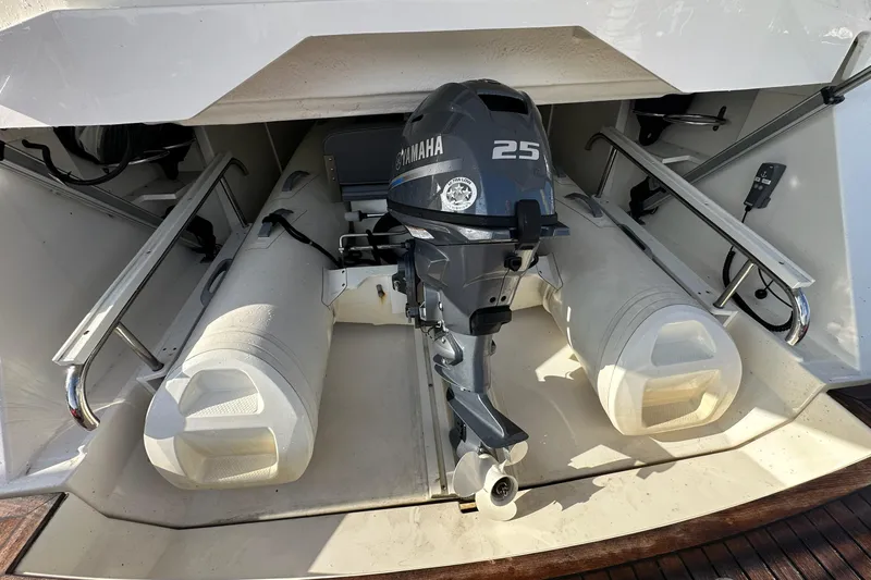 Happy Ours Yacht Photos Pics 2019 Riviera 5400 Sport Yacht with Yamaha 25 outboard motor in storage compartment.