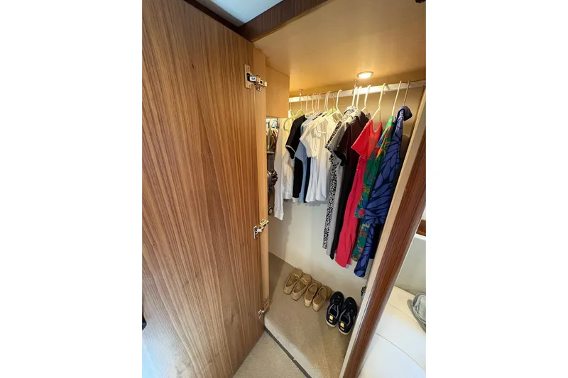 Happy Ours Yacht Photos Pics Closet in 2019 Riviera 5400 Sport Yacht with clothes and shoes neatly organized.