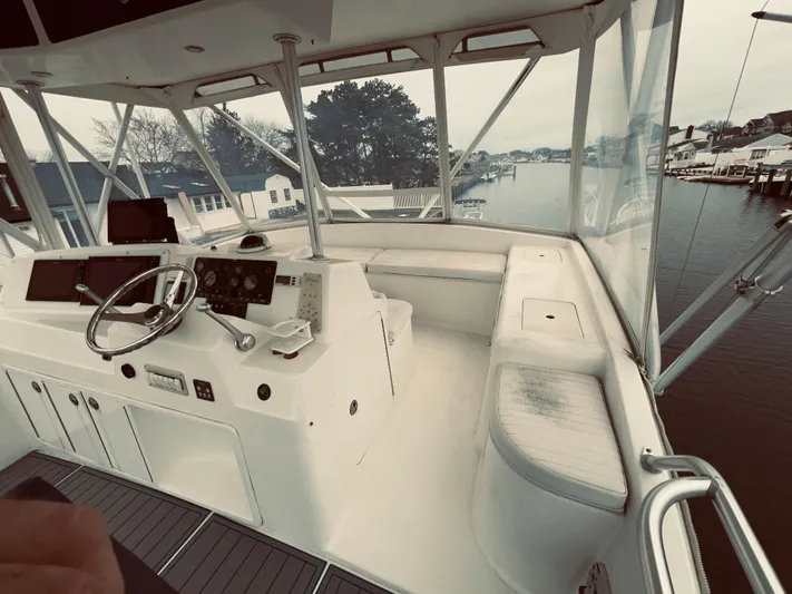 Rock & Roll IV Yacht Photos Pics Cockpit of a 2002 Egg Harbor 42 Sport Fish boat with steering wheel and navigation equipment.