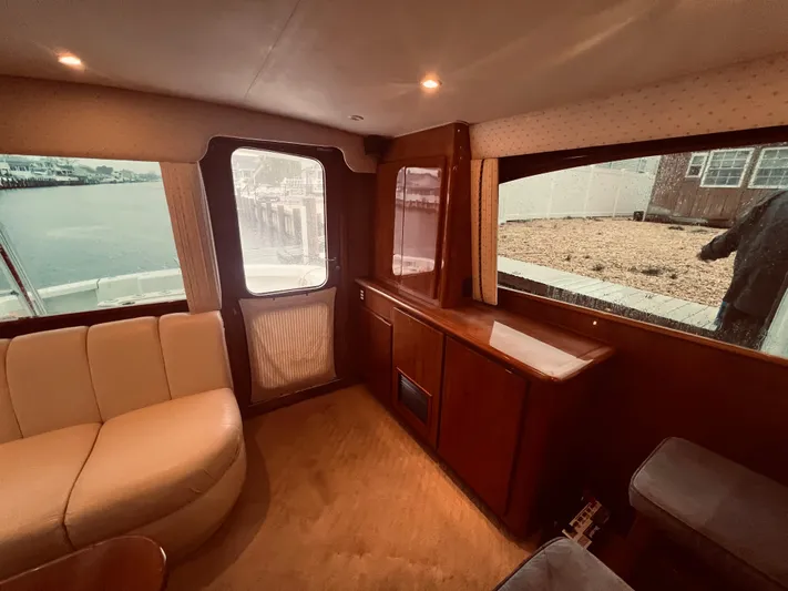 Rock & Roll IV Yacht Photos Pics Interior of 2002 Egg Harbor 42 Sport Fish yacht with beige seating and wooden cabinetry.