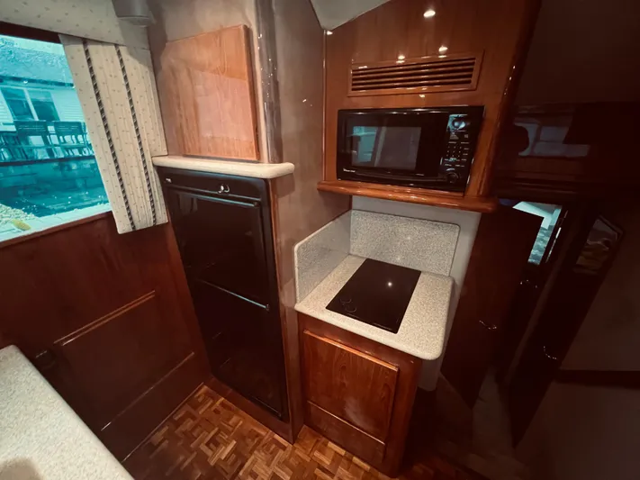 Rock & Roll IV Yacht Photos Pics Interior kitchen of 2002 Egg Harbor 42 Sport Fish yacht with microwave, stove, and refrigerator.