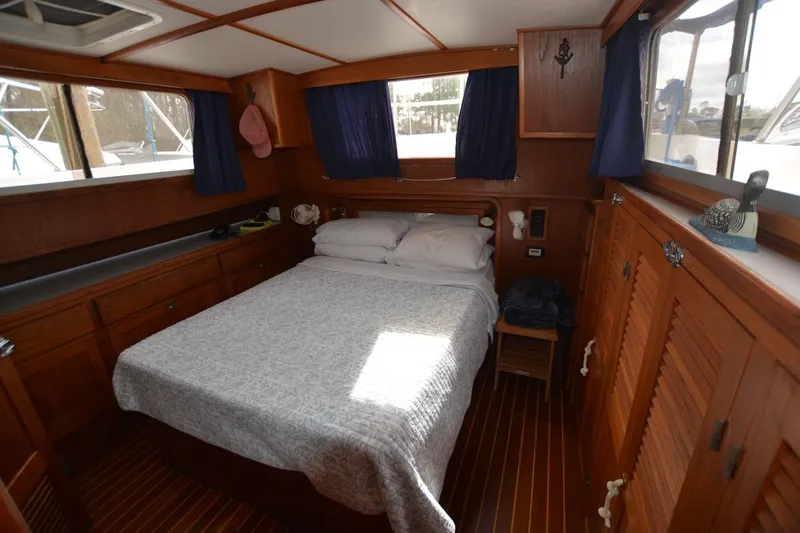 Pau Hana Yacht Photos Pics Cozy cabin interior of 1998 Monk Trawler with wooden furnishings and a comfortable bed.