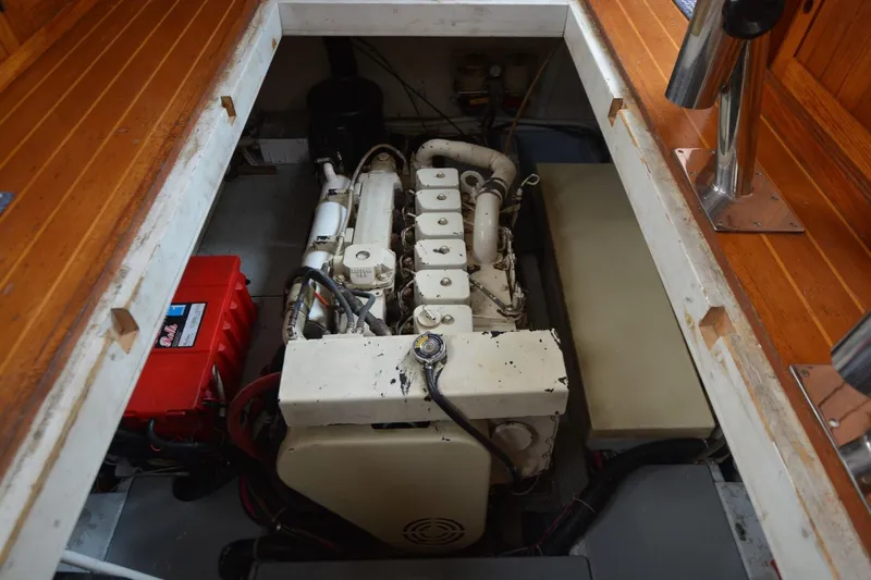 Pau Hana Yacht Photos Pics Engine compartment of a 1998 Monk Trawler, featuring a diesel engine and battery setup.
