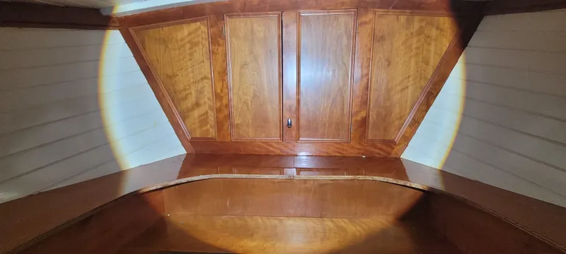 Termo Yacht Photos Pics Wooden interior of 2000 Custom Holland Hardtop Cruiser, featuring polished cabinetry and paneling.