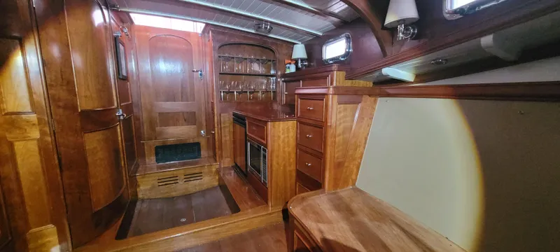 Termo Yacht Photos Pics Interior of a 2000 Custom Holland Hardtop Cruiser with wooden cabinetry and seating.