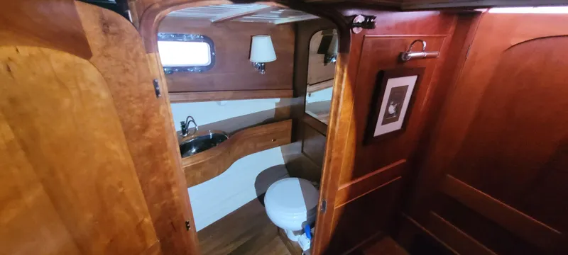 Termo Yacht Photos Pics Interior of 2000 Custom Holland Hardtop Cruiser with wooden cabinetry and compact bathroom.