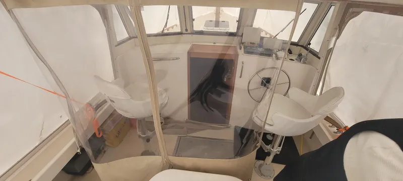 Termo Yacht Photos Pics Interior of 2000 Custom Holland Hardtop Cruiser with steering wheel and seating.