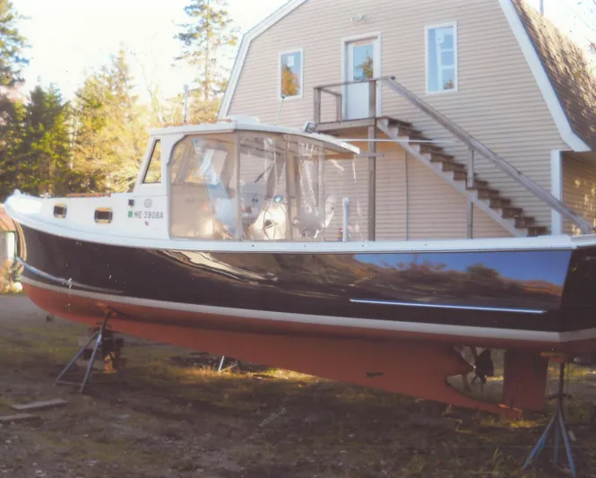 Termo Yacht Photos Pics Custom 2000 Holland Hardtop Cruiser boat on land near a house with stairs.