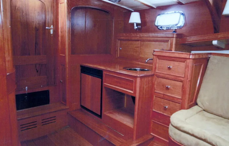 Termo Yacht Photos Pics Interior of 2000 Custom Holland Hardtop Cruiser with wooden cabinetry and compact kitchenette.
