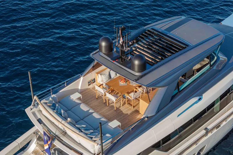 Firefly Yacht Photos Pics Luxurious 2025 Sanlorenzo SX76 yacht with spacious deck and elegant seating area.