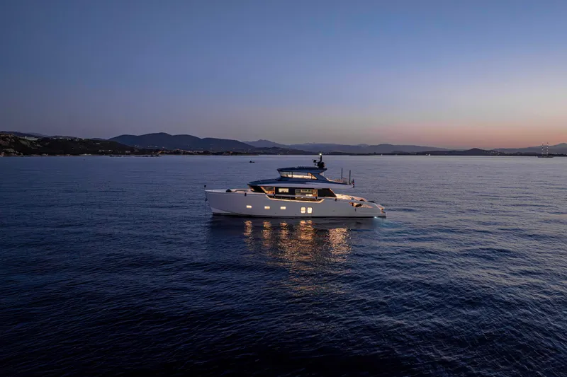 Firefly Yacht Photos Pics Sanlorenzo SX76 2025 yacht at sunset on calm waters.