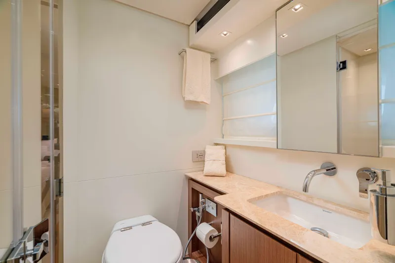 Firefly Yacht Photos Pics Luxurious bathroom in 2025 Sanlorenzo SX76 yacht, featuring modern fixtures and elegant design.
