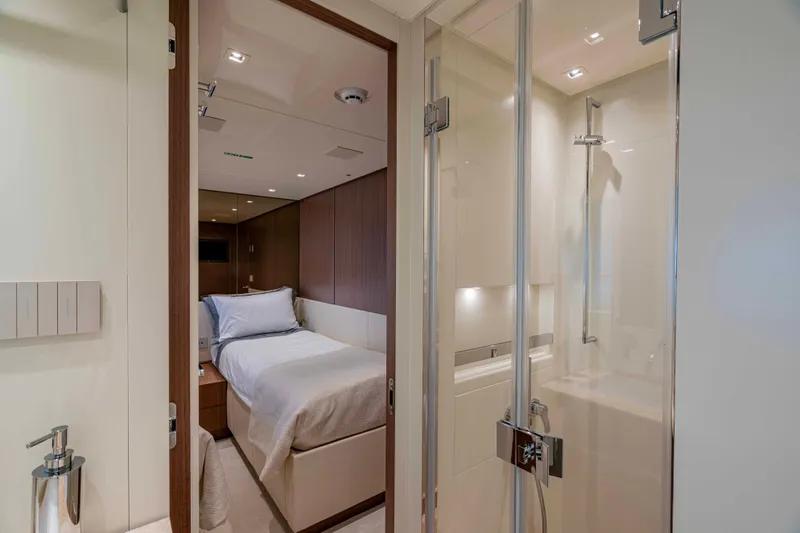 Firefly Yacht Photos Pics Luxurious Sanlorenzo SX76 2025 yacht interior with modern bedroom and sleek bathroom design.