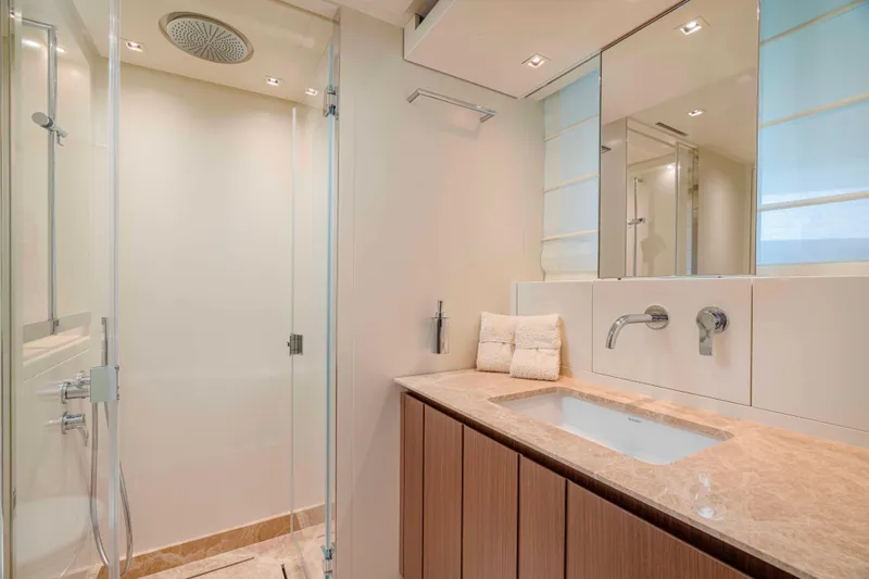 Firefly Yacht Photos Pics Luxurious bathroom in 2025 Sanlorenzo SX76 yacht with modern fixtures and elegant design.